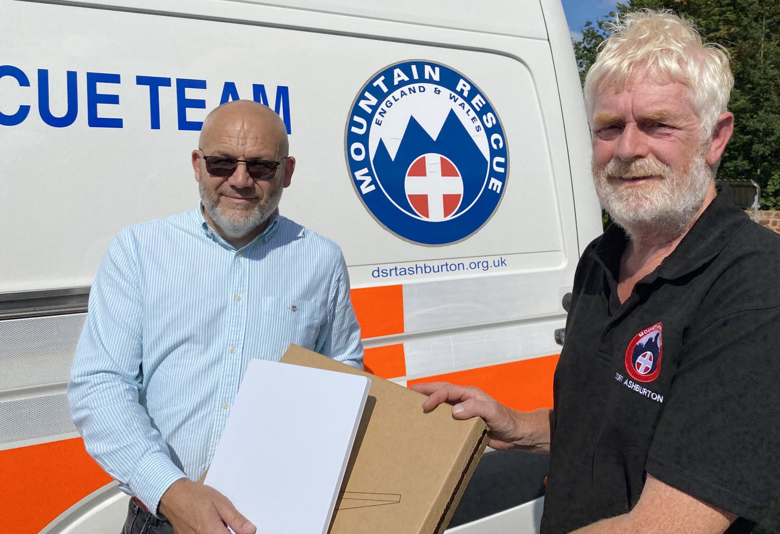 Unity5 Vice Chair Dave Herbert presents a Starlink Mini to DSRT Ashburton Search Manager Ian Lowcock